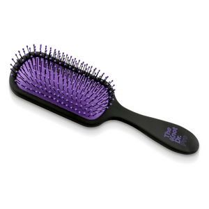 Pro detangling hairbrush in black with purple pad laying flat
